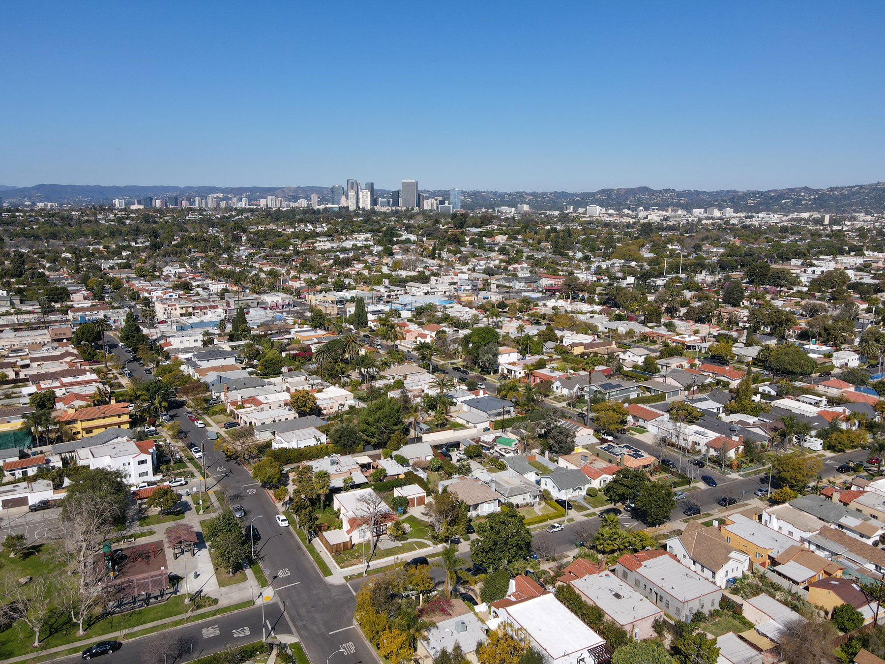 Wide aerial view of West Los Angeles, California, showcasing residential streets, mature neighborhoods, and the surrounding Westside skyline.